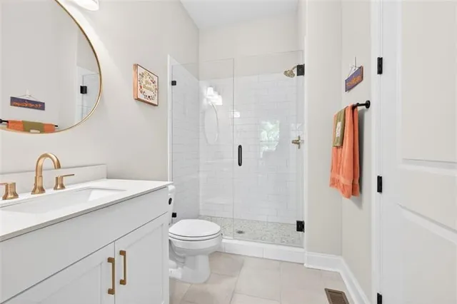 a kitchen with granite countertop a stove and a white cabinets