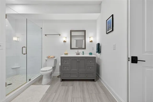 an aerial view of residential houses with outdoor space and trees