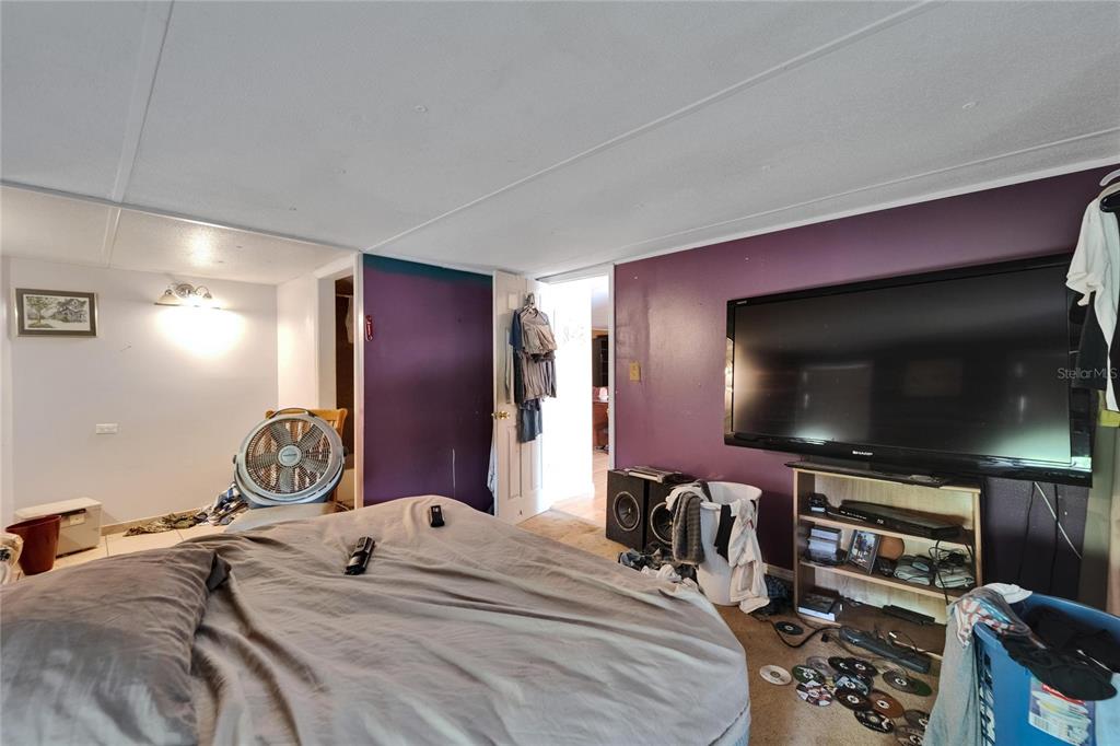 13907 Raulerson Road, Unit PARCEL A Riverview, FL 33569 - Photo 20 of 30 a bedroom with a bed and a flat screen tv