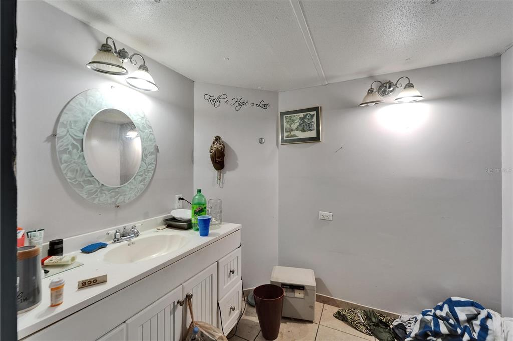13907 Raulerson Road, Unit PARCEL A Riverview, FL 33569 - Photo 21 of 30 a bathroom with a sink vanity and a mirror