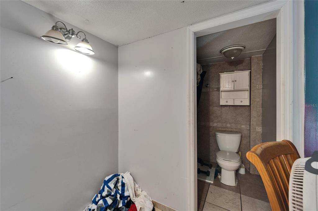 13907 Raulerson Road, Unit PARCEL A Riverview, FL 33569 - Photo 22 of 30 a bathroom with a toilet a sink a mirror and shower