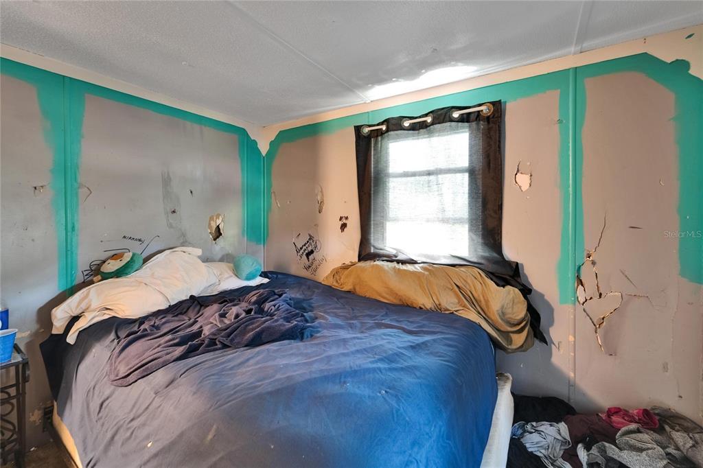 13907 Raulerson Road, Unit PARCEL A Riverview, FL 33569 - Photo 24 of 30 a bed sitting in a bedroom next to a window