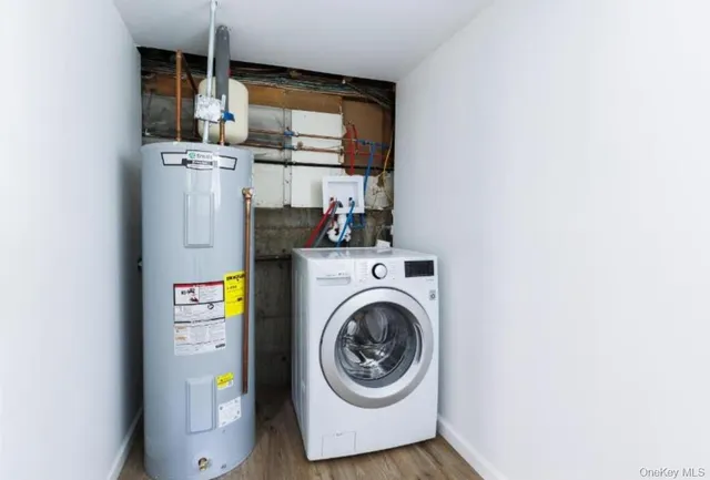 a view of washer and dryer with kitchen in the background