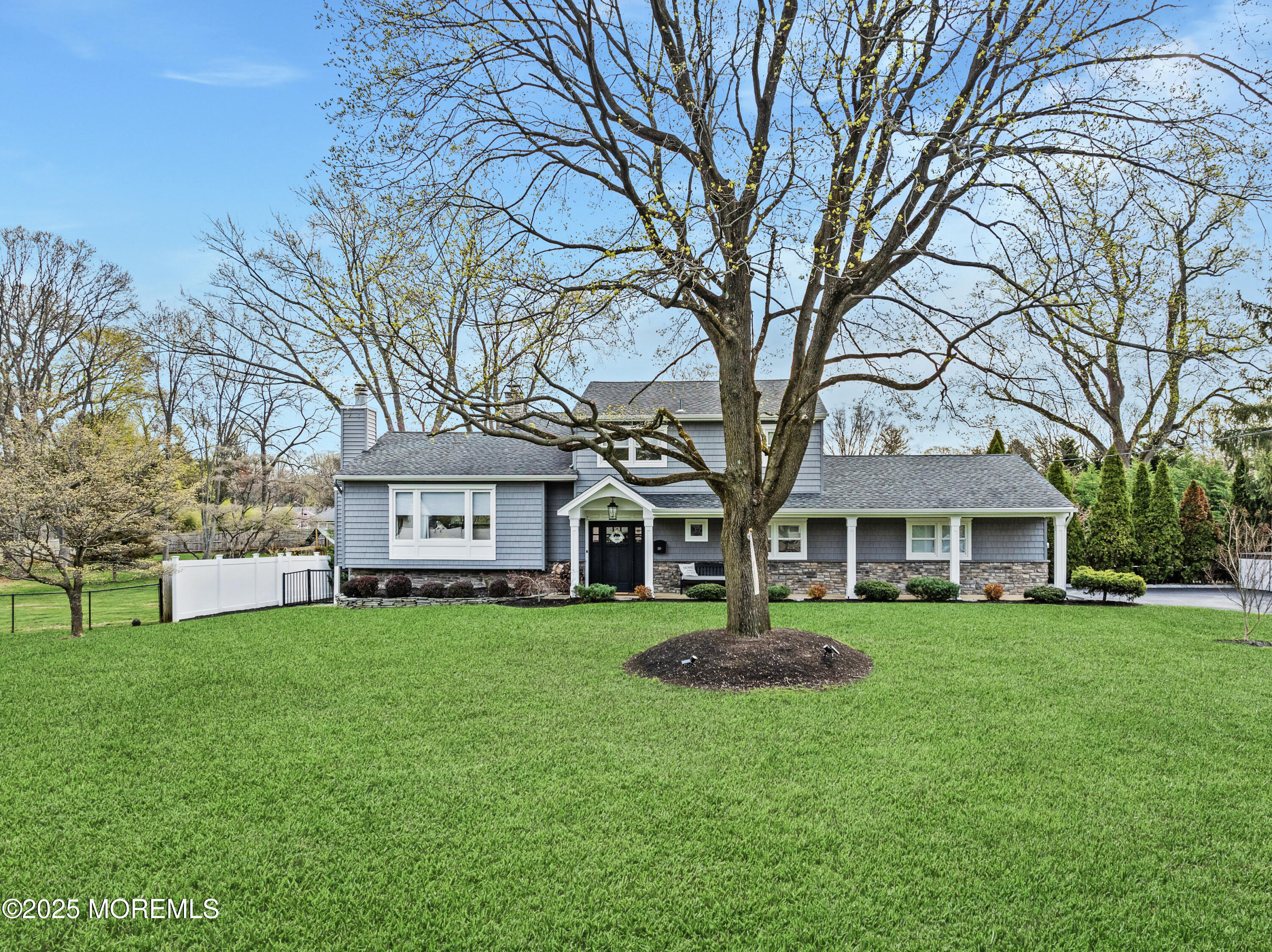 110 Jumping Brook Road Lincroft, NJ 07738 - Photo 3 of 48 a large house with a big yard and large trees