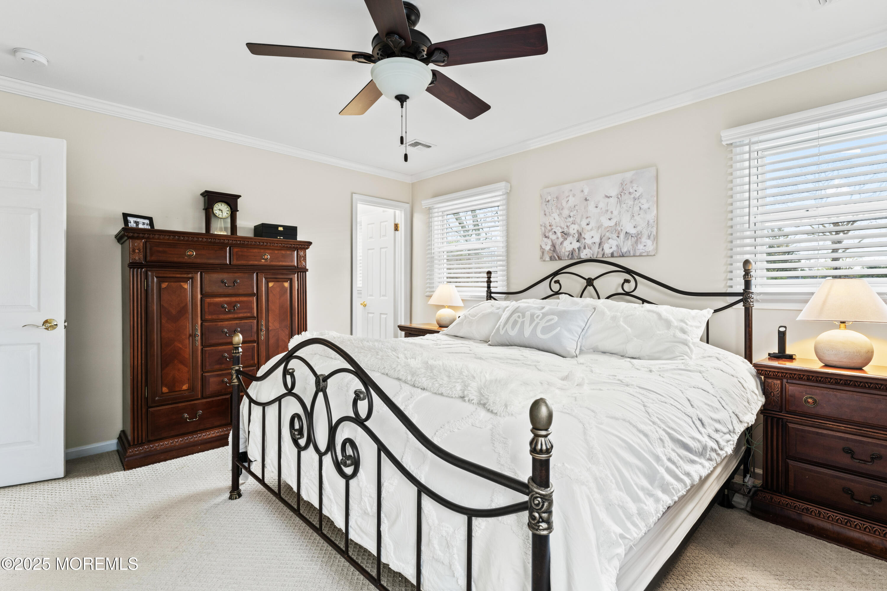 110 Jumping Brook Road Lincroft, NJ 07738 - Photo 32 of 48 a bedroom with a bed and a chandelier