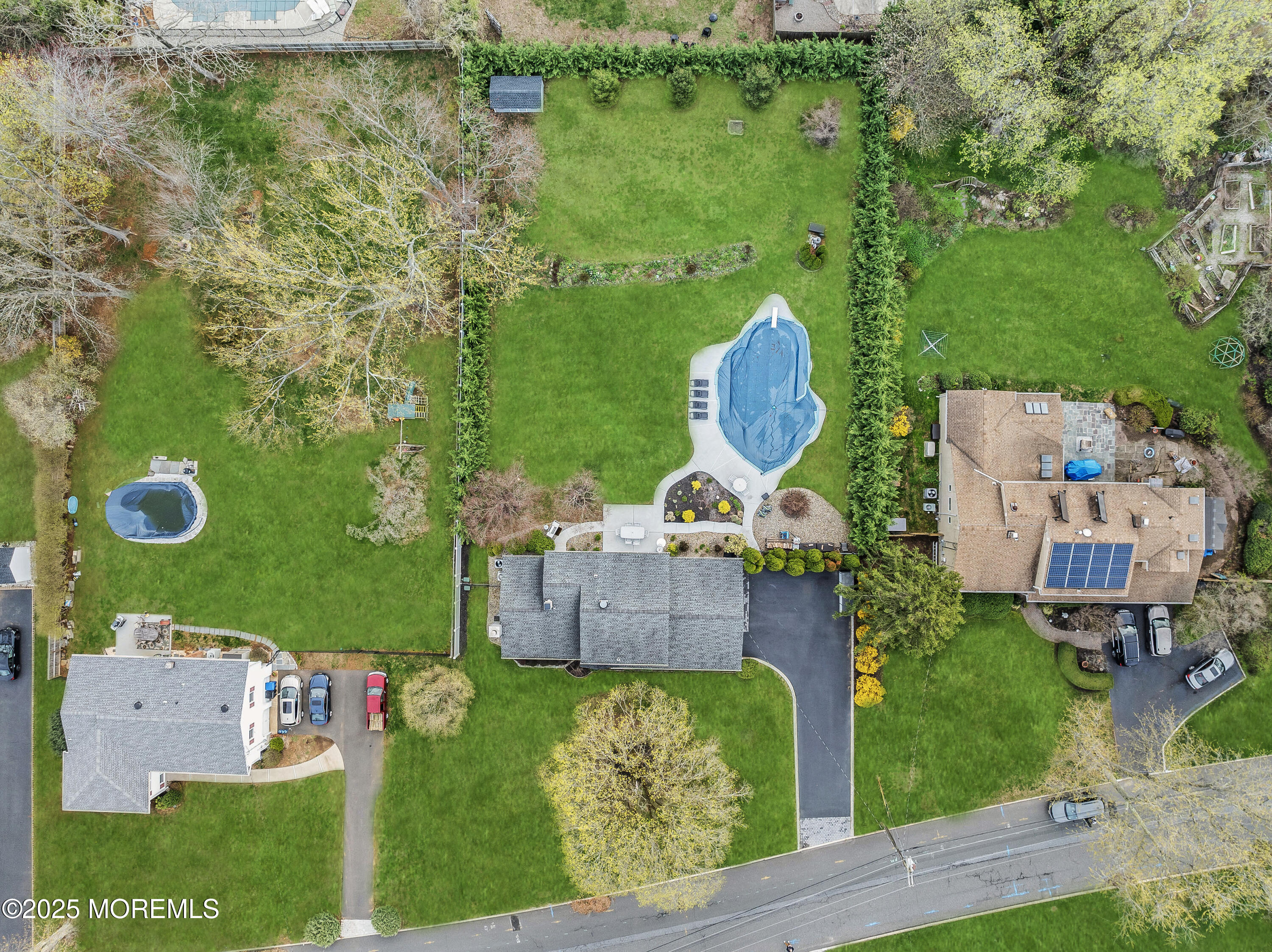 110 Jumping Brook Road Lincroft, NJ 07738 - Photo 6 of 48 an aerial view of a house with a garden and outdoor seating