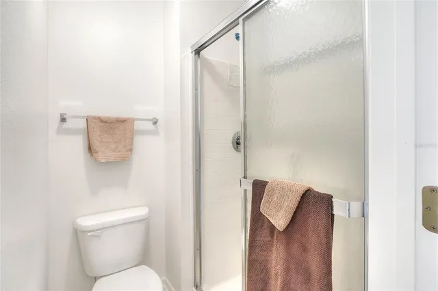 an empty room with a ceiling fan and a window