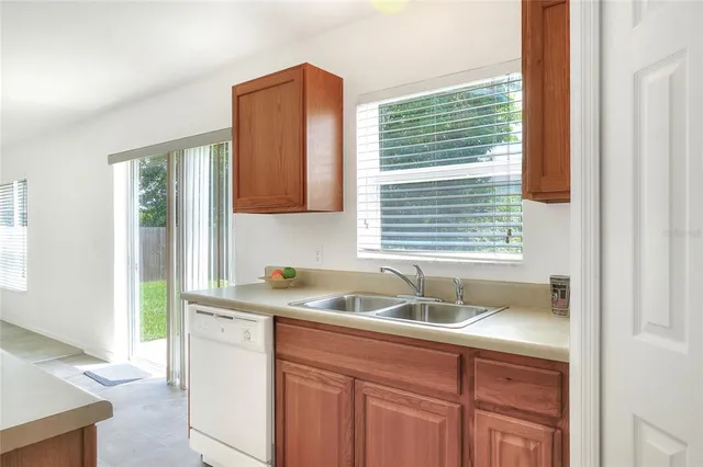 a kitchen with stainless steel appliances a refrigerator and a sink
