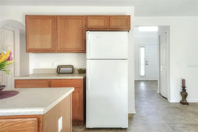 a kitchen with a sink cabinets and wooden floor
