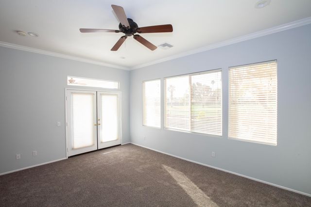 a view of a livingroom with a ceiling fan and window