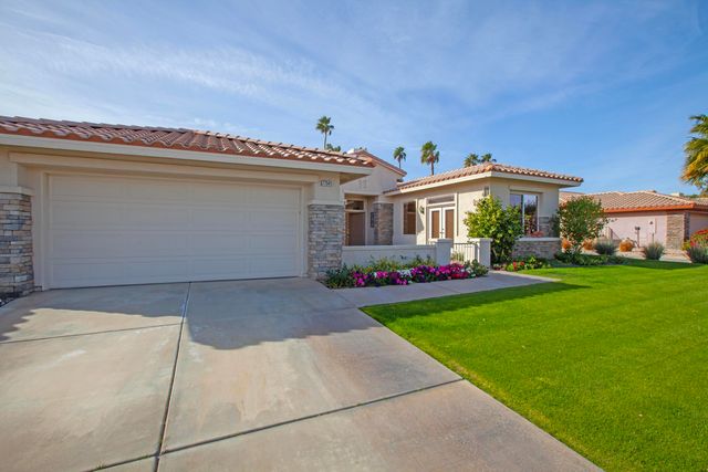 a front view of house with yard and outdoor seating
