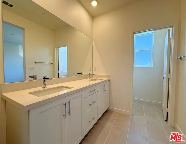 a bathroom with a granite countertop sink a mirror and a