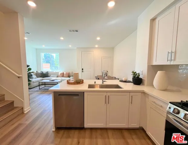 a kitchen with sink and cabinets