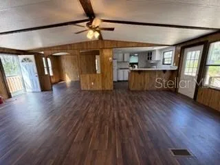 a view of a livingroom with hardwood floor and a ceiling fan