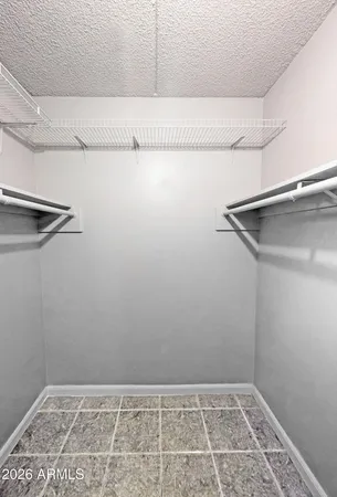 an empty room with a ceiling fan and window