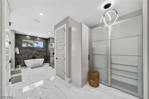a bathroom with a tub and shower