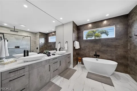 a bathroom with a double vanity sink and a mirror