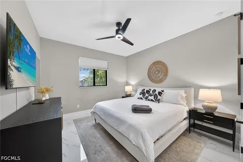 a bedroom with a bed and a chandelier