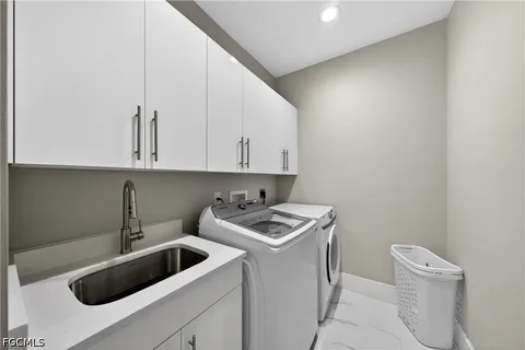 a view of a kitchen with sink and washing machine