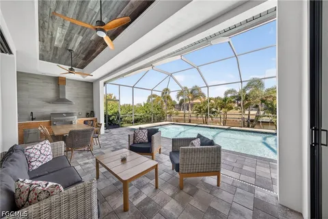 a outdoor living space with furniture and a black umbrella