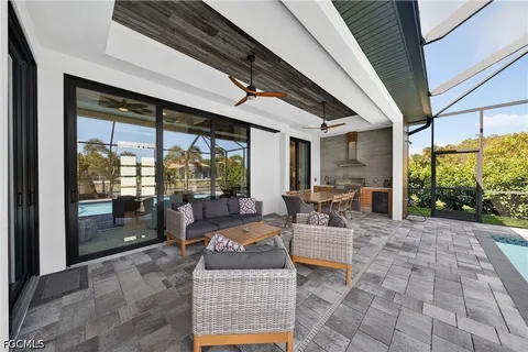 a building outdoor space with patio furniture and potted plants