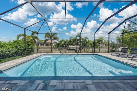 an aerial view of residential houses with outdoor space and swimming pool