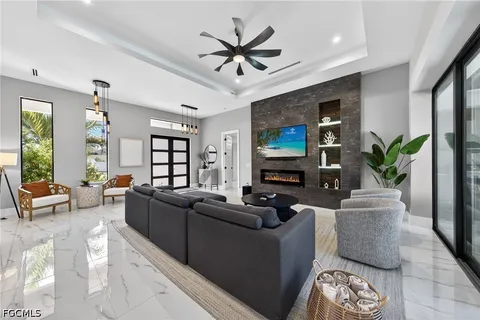 a living room with furniture a large window and a flat screen tv