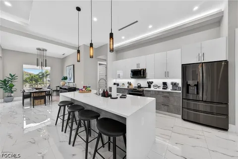 a kitchen with a sink a counter and stainless steel appliances