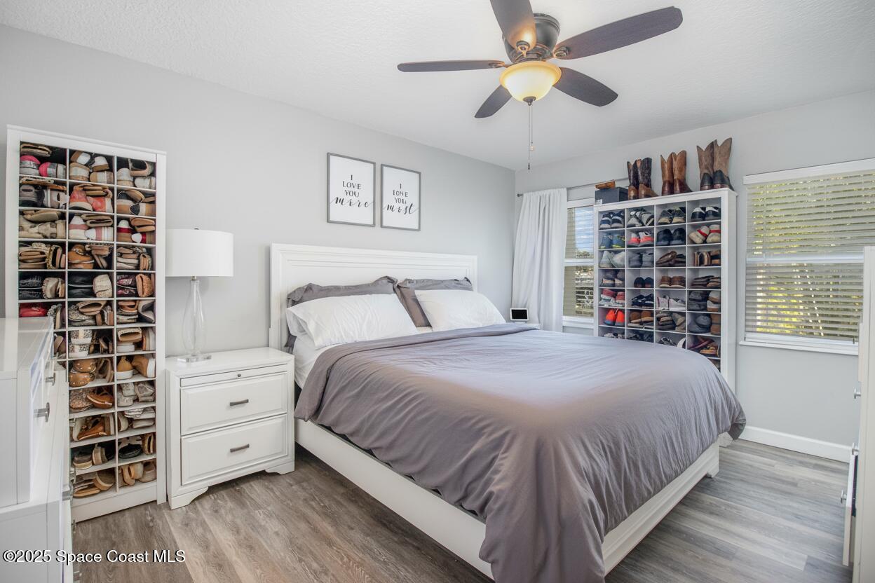 964 Bucknell Place Rockledge, FL 32955 - Photo 12 of 30 a bedroom with a large bed and a chandelier