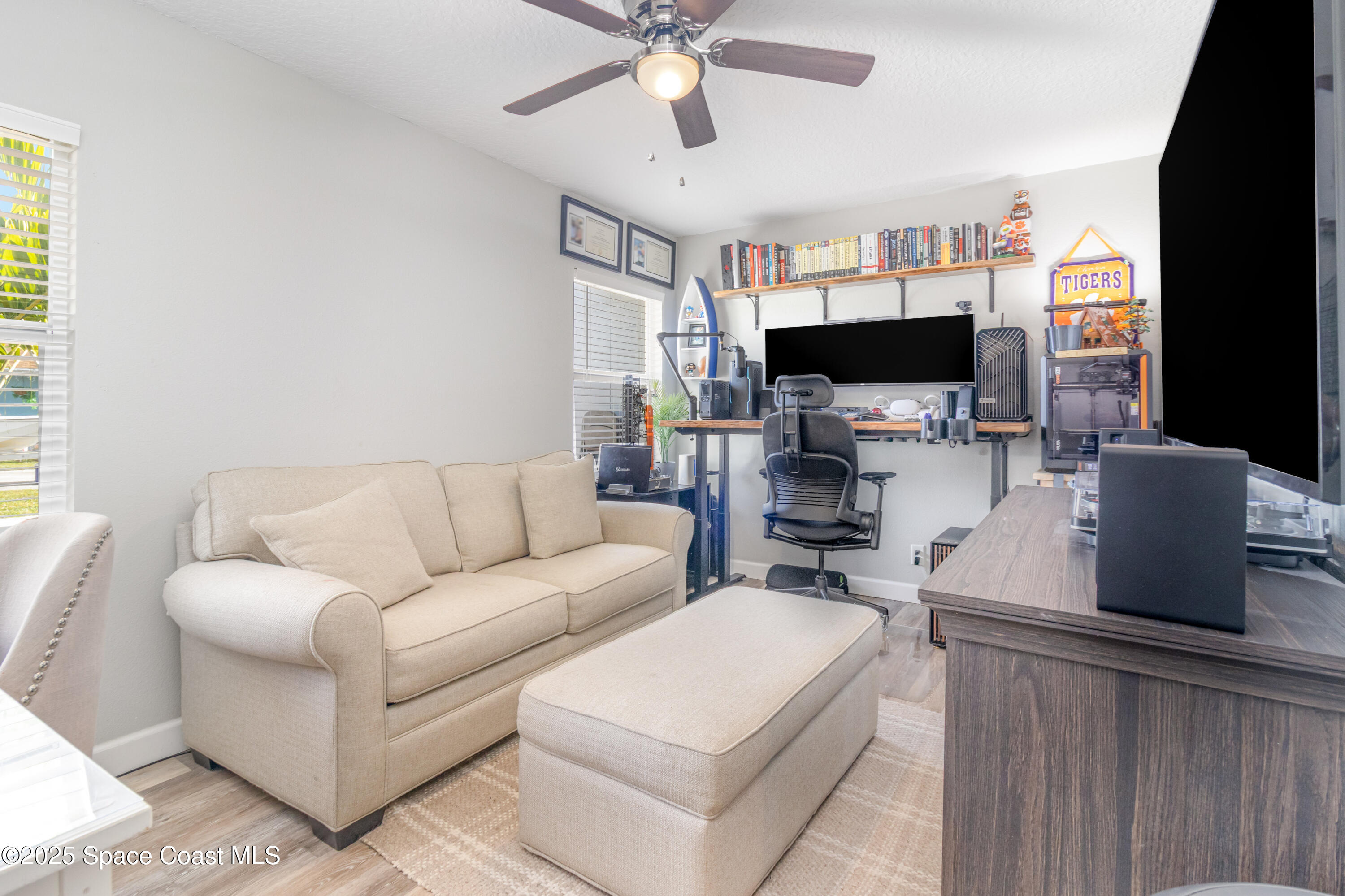 964 Bucknell Place Rockledge, FL 32955 - Photo 16 of 30 a living room with furniture a flat screen tv and a fireplace