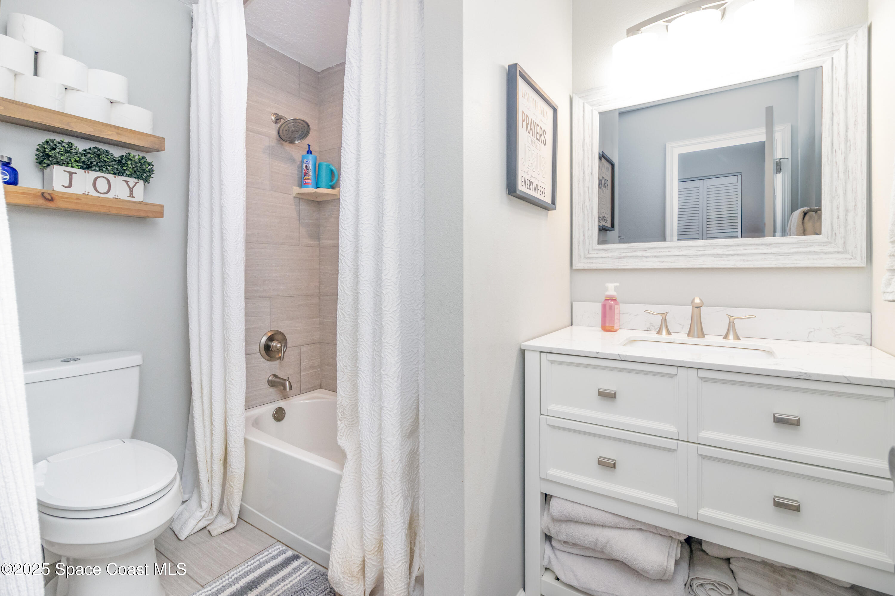 964 Bucknell Place Rockledge, FL 32955 - Photo 20 of 30 a bathroom with a sink and a mirror