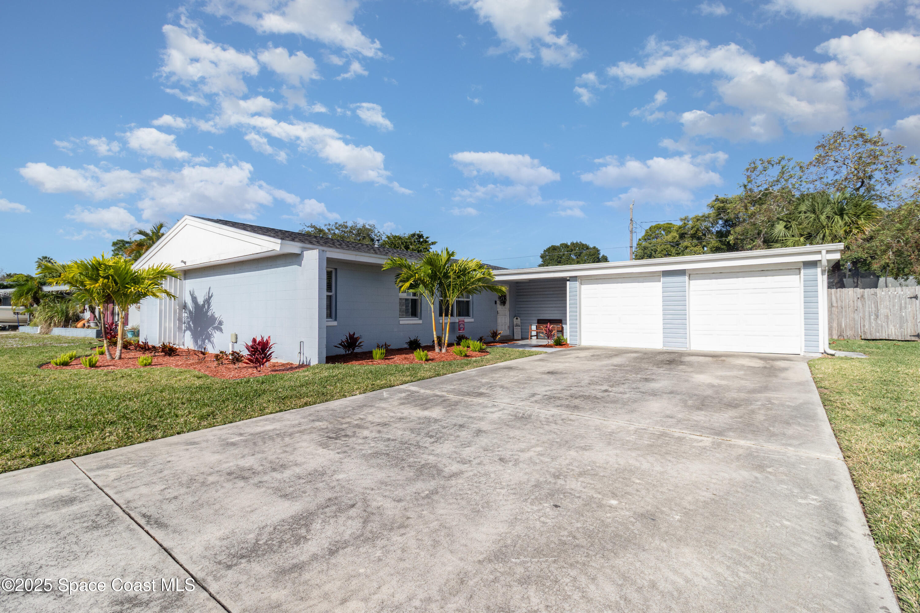 964 Bucknell Place Rockledge, FL 32955 - Photo 2 of 30 a view of a house with a yard and garage