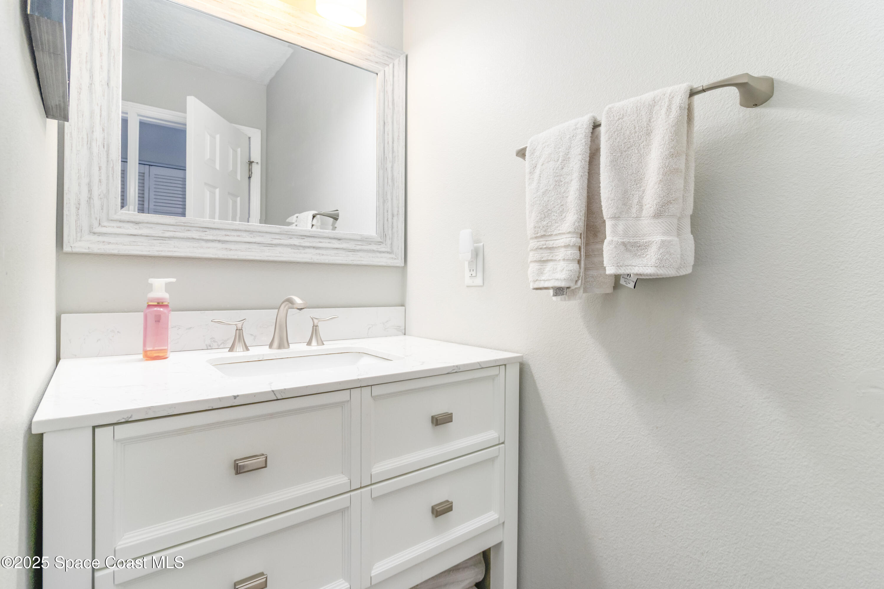 964 Bucknell Place Rockledge, FL 32955 - Photo 21 of 30 a bathroom with a sink and a mirror