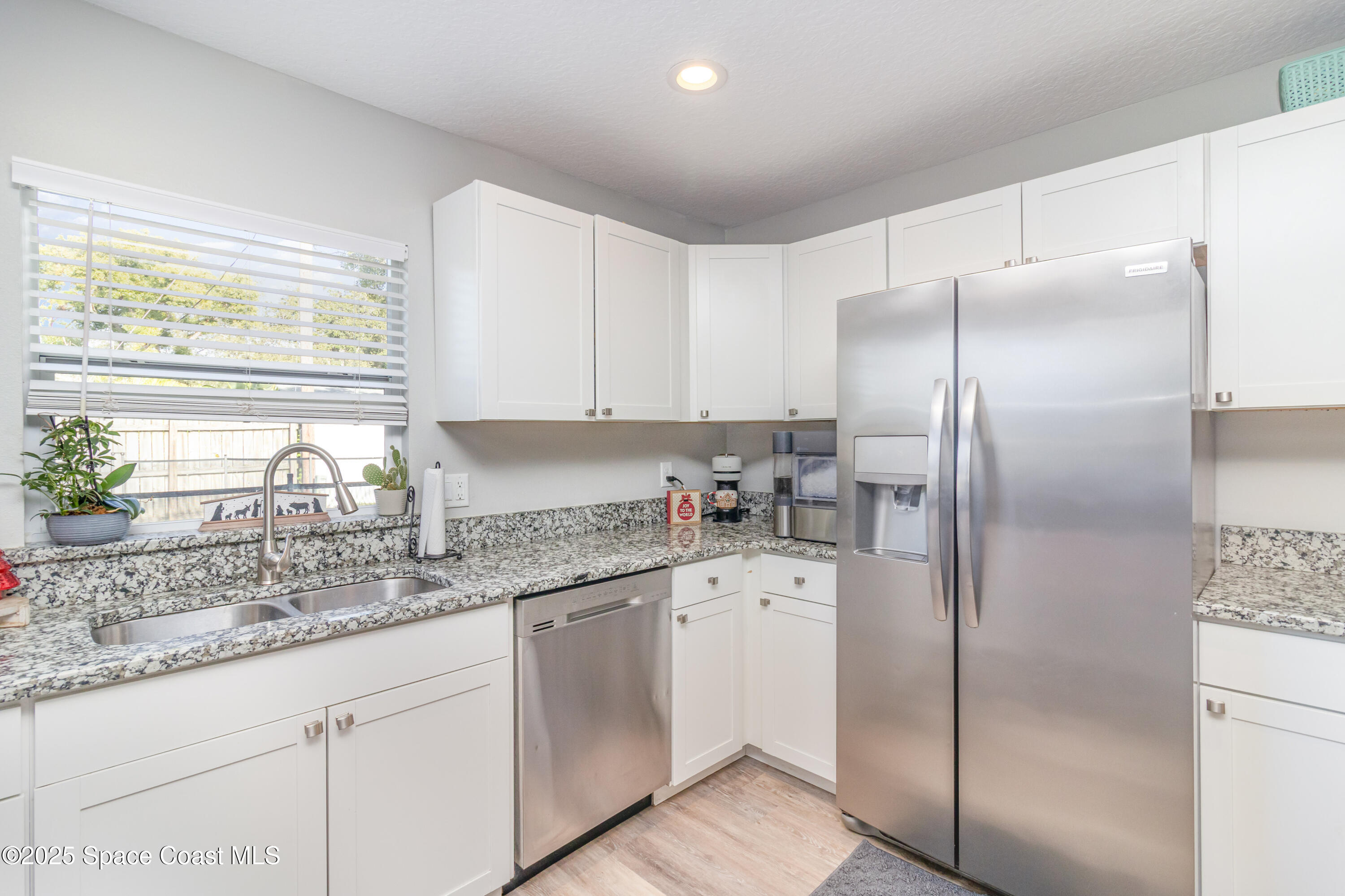 964 Bucknell Place Rockledge, FL 32955 - Photo 6 of 30 a kitchen with stainless steel appliances granite countertop a refrigerator and a sink