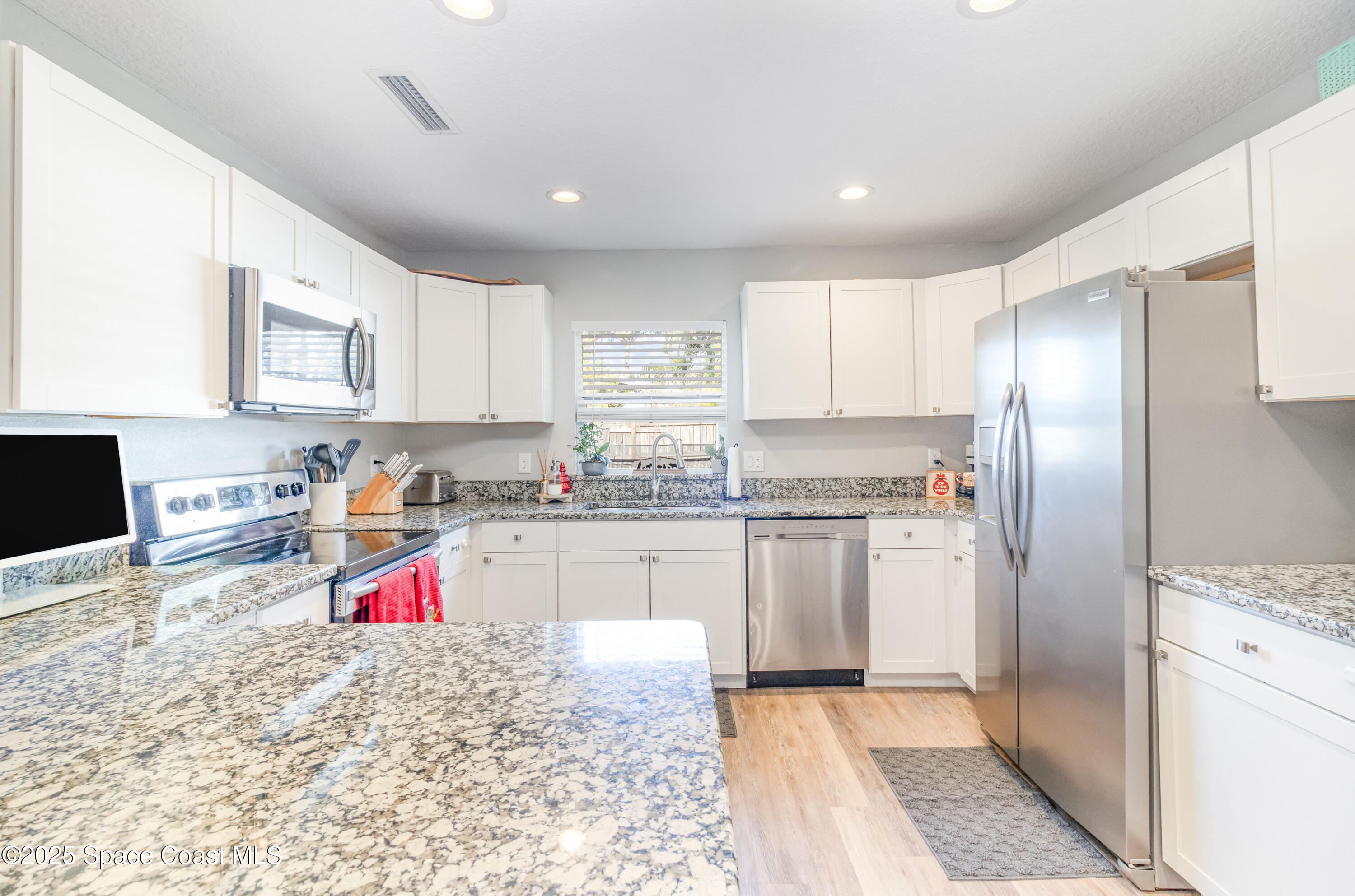 964 Bucknell Place Rockledge, FL 32955 - Photo 8 of 30 a kitchen that has a refrigerator and a sink