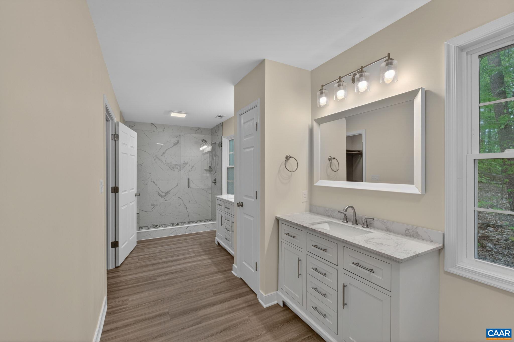 673 Cedar Lane Road Palmyra, VA 22963 - Photo 25 of 47 a bathroom with a double vanity sink mirror and shower