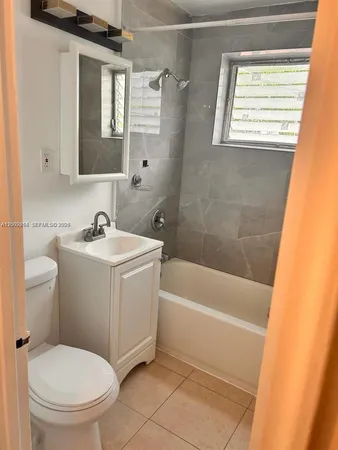 a white bath tub sitting next to a white toilet