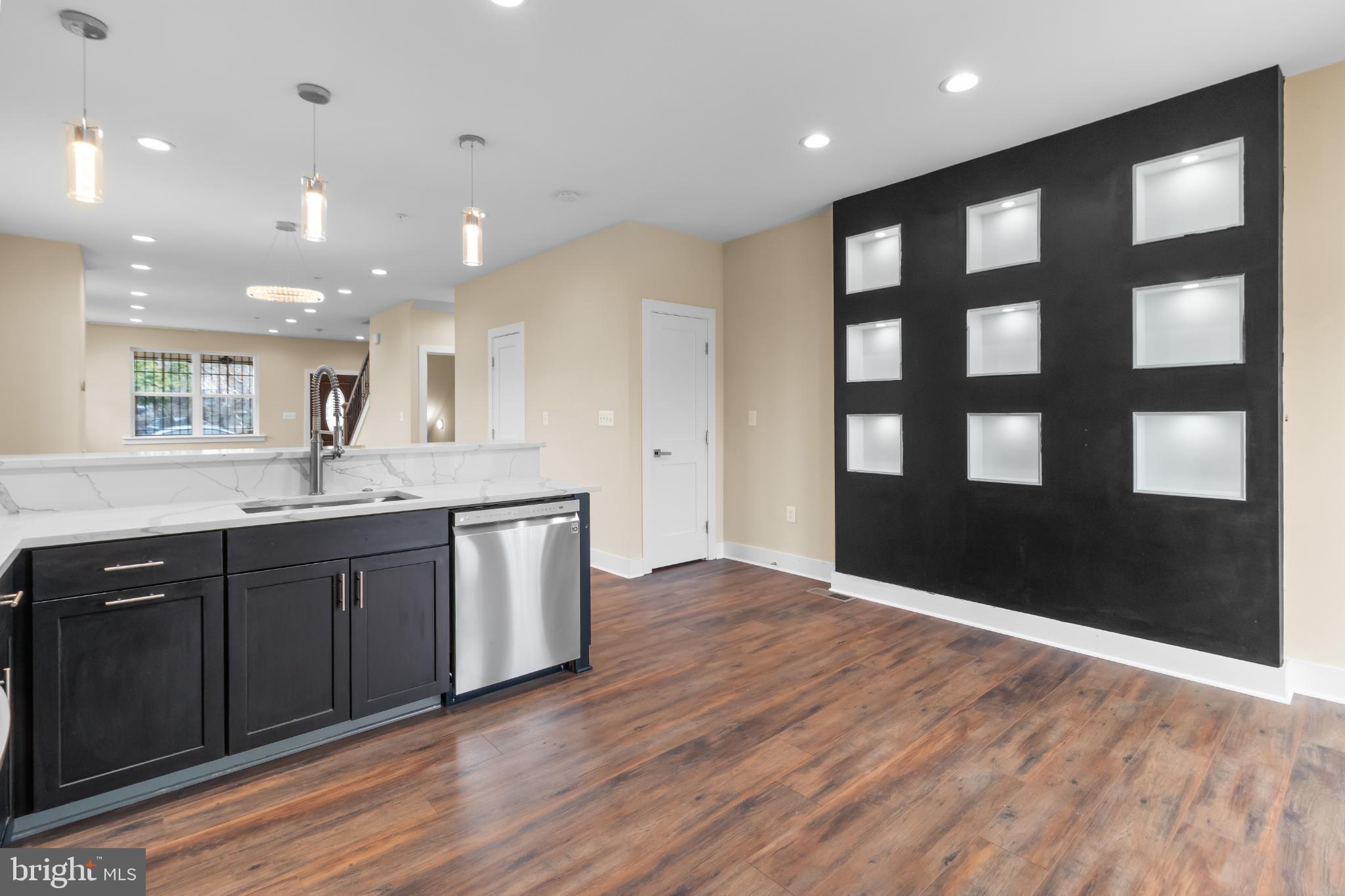 2405 Naylor Road Southeast Washington, DC 20020 - Photo 12 of 23 a open kitchen with kitchen island a sink dishwasher and a large window