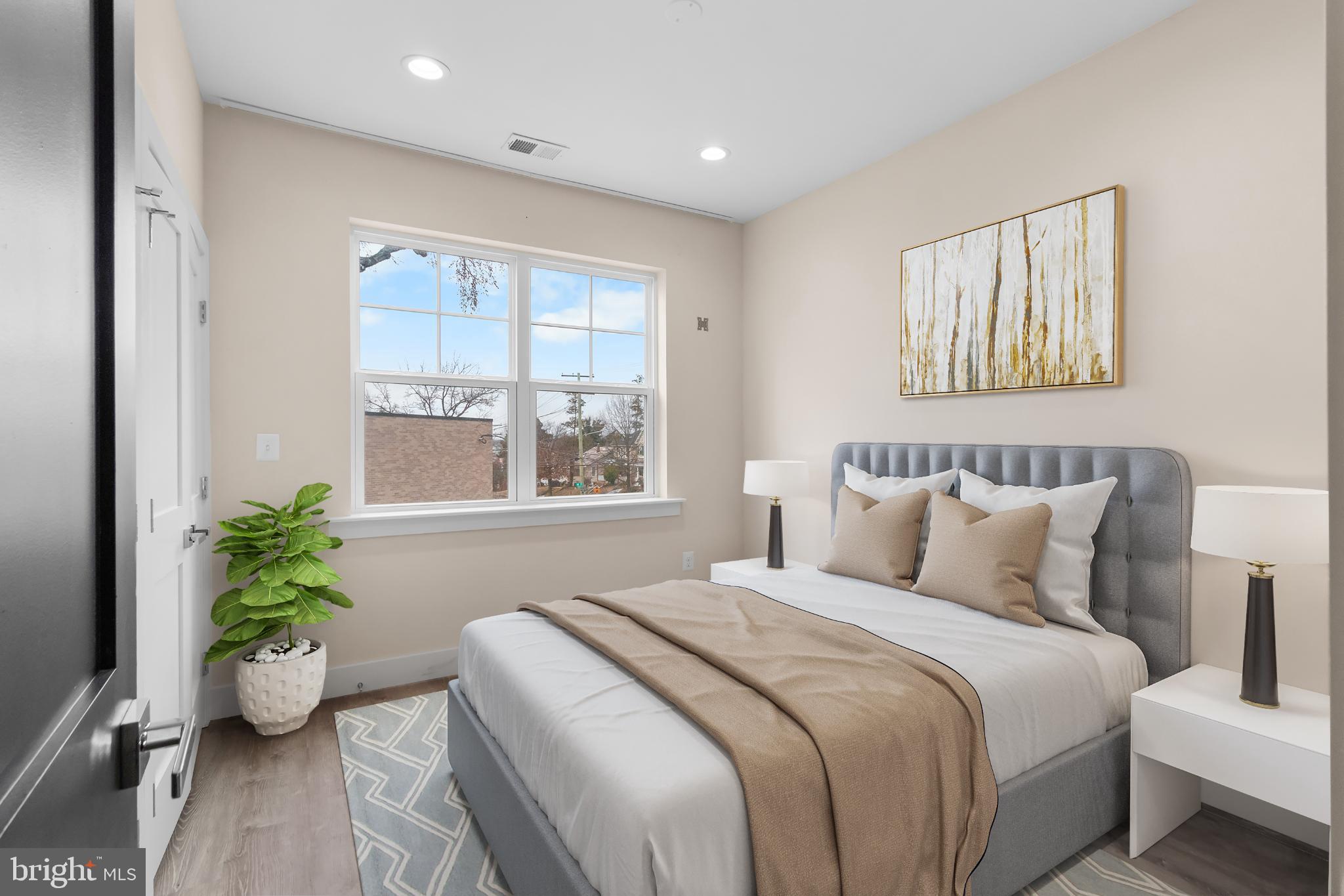 2405 Naylor Road Southeast Washington, DC 20020 - Photo 4 of 23 a spacious bedroom with a bed and a potted plant