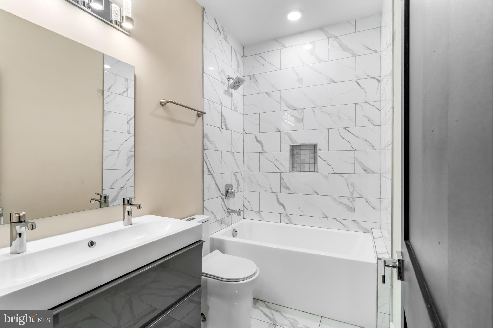 2405 Naylor Road Southeast Washington, DC 20020 - Photo 9 of 23 a bathroom with a bathtub shower sink mirror and toilet