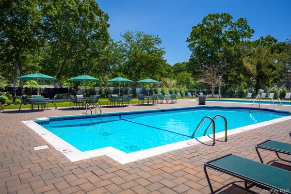 a view of a swimming pool with lounge chair