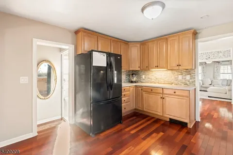 a kitchen with a refrigerator a sink and cabinets