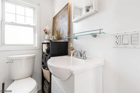 a bathroom with a sink toilet and mirror