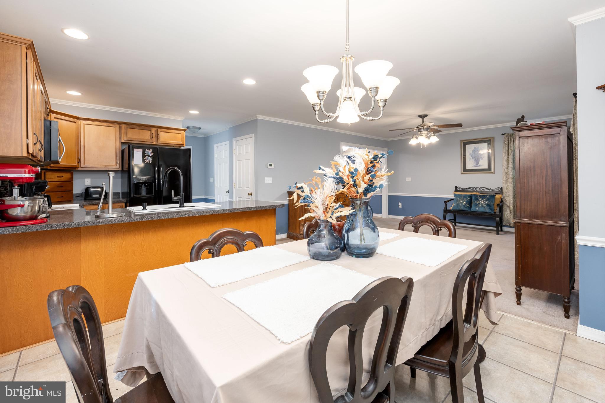 613 Lakeside Drive Salisbury, MD 21801 - Photo 19 of 50 a view of a dining room with furniture and chandelier