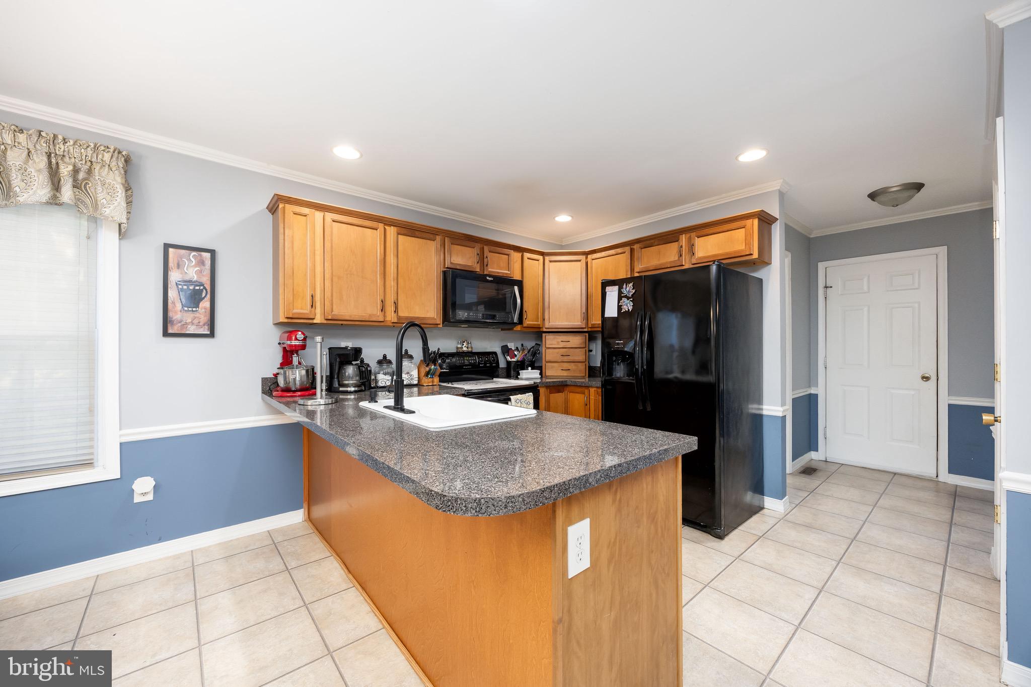 613 Lakeside Drive Salisbury, MD 21801 - Photo 20 of 50 a kitchen with stainless steel appliances granite countertop a refrigerator and a sink