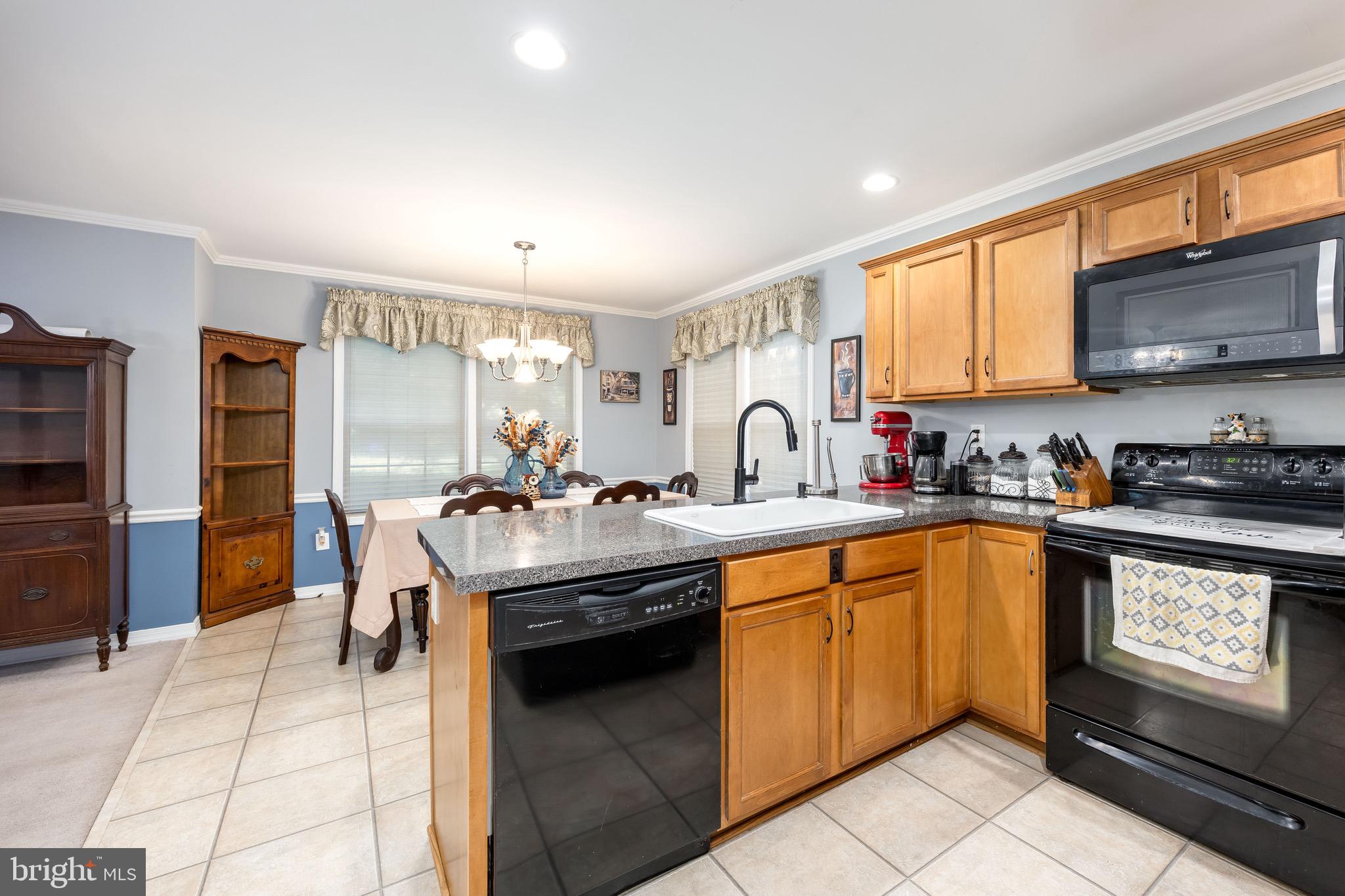 613 Lakeside Drive Salisbury, MD 21801 - Photo 22 of 50 a kitchen with stainless steel appliances granite countertop a sink stove and refrigerator