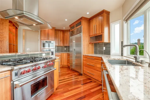 a kitchen with granite countertop a stove and a microwave