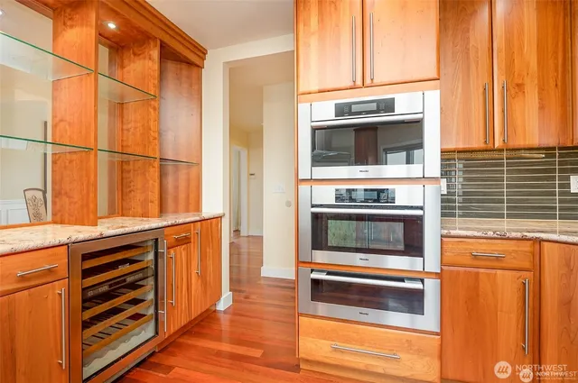 a living room with a fireplace cabinet and a large window