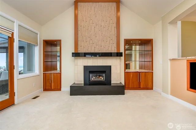 a bedroom with a bed and large windows