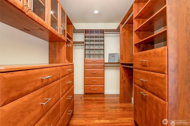 a bathroom with a tub and large windows